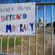 People pass signs of support near the US Capital in Washington, DC on January 10, 2021. - Donald Trump faced fresh calls Sunday from some members of his own party to resign over the violent incursion into the US Capitol, as the threat builds for a historic second impeachment effort in his final 10 days in the White House.